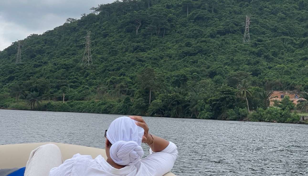 Serene lake cruise with lush green mountain scenery in Ghana, perfect for sightseeing and outdoor adventures.