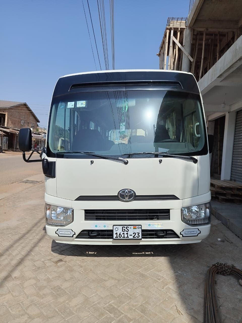 Front view of Toyota Coaster bus used for comfortable group tours in Ghana with Timeh Tours