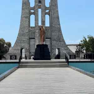 Iconic Ghana monument with statue and modern architecture, perfect for cultural tours.