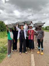 Tourist experiencing daily life in a local village in Northern Ghana during a cultural tour with Timeh Tours