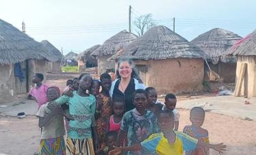 Tourist interacting with local children in a village in Northern Ghana during a cultural experience with Timeh Tours