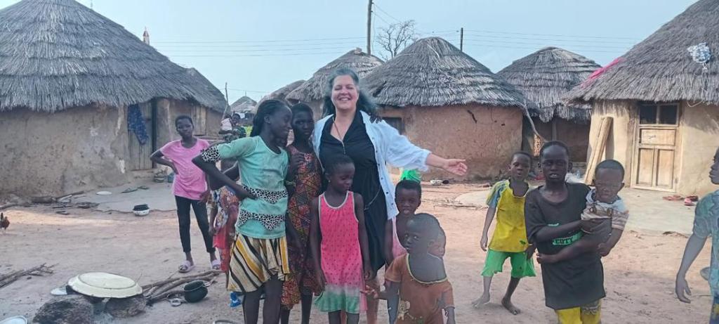Tourist interacting with children in a local community in Northern Ghana during a guided cultural tour with Timeh Tours