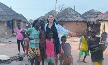 Tourist interacting with children in a local community in Northern Ghana during a guided cultural tour with Timeh Tours